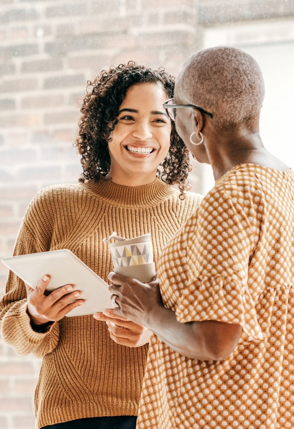 caregiver reading with senior caregiver assisting with home care services